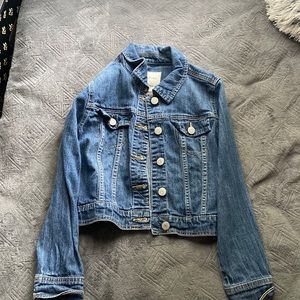 i’m selling a denim jacket it is a kids large (10/12) and the color is blue